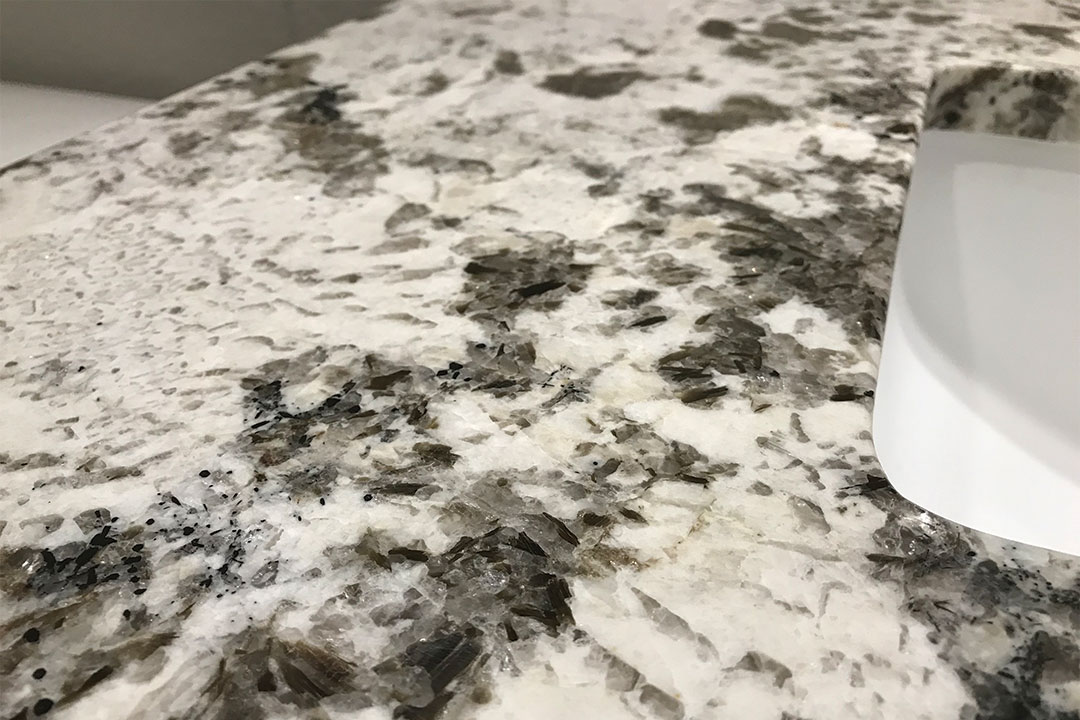 closeup of guest bathroom granite