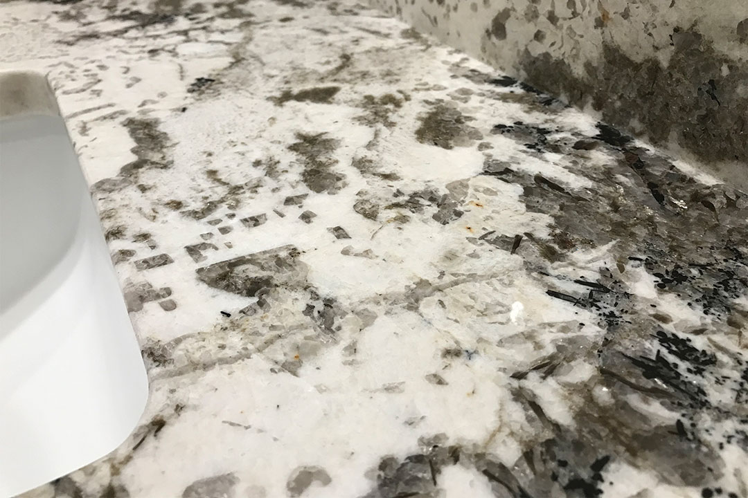 closeup of guest bathroom granite