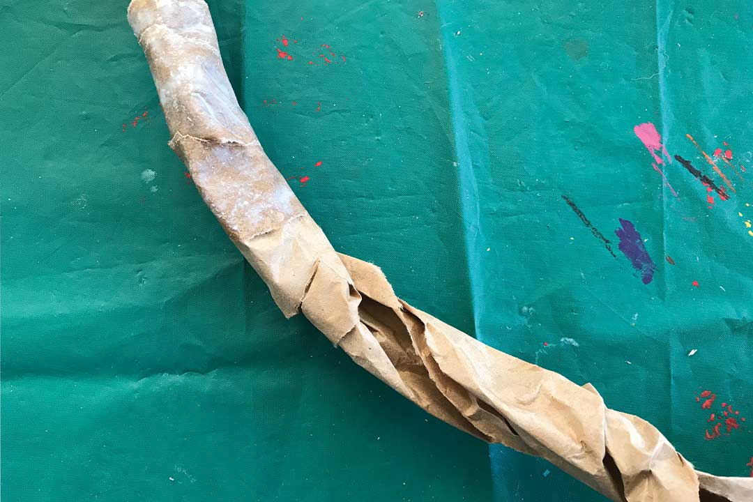 wrap the twisted paper of the antler with small strips of paper mache packing paper