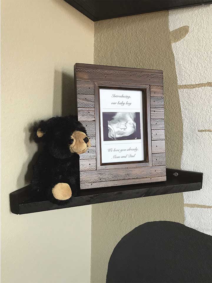 DIY wood corner shelves with wood picture frame and black bear.