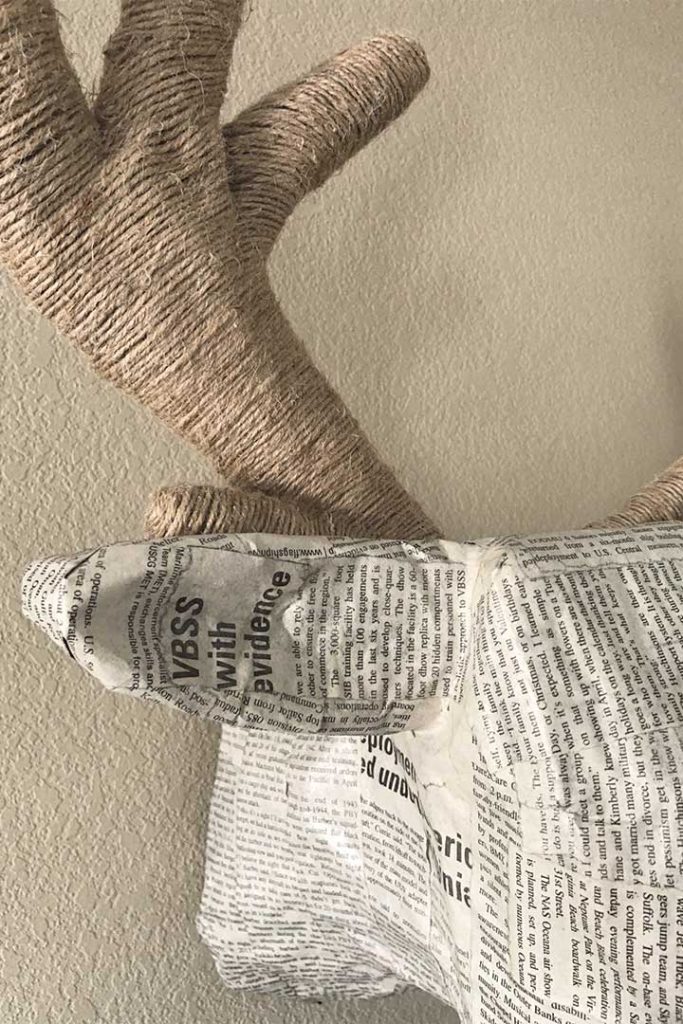 close-up of twine and newspaper on paper mache deer head