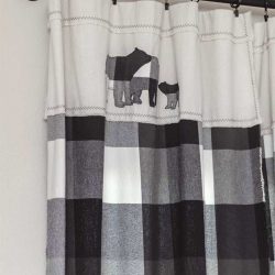 woodland nursery curtains made of black and white buffalo check flannel, drop cloth, and bear appliques