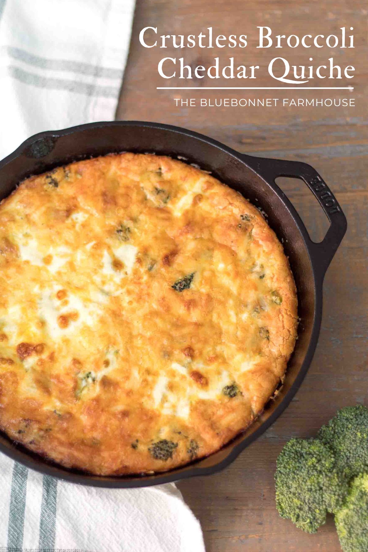 baked quiche in a cast iron skillet with broccoli florets on a farmhouse table. text reads "crustless broccoli cheddar quiche"
