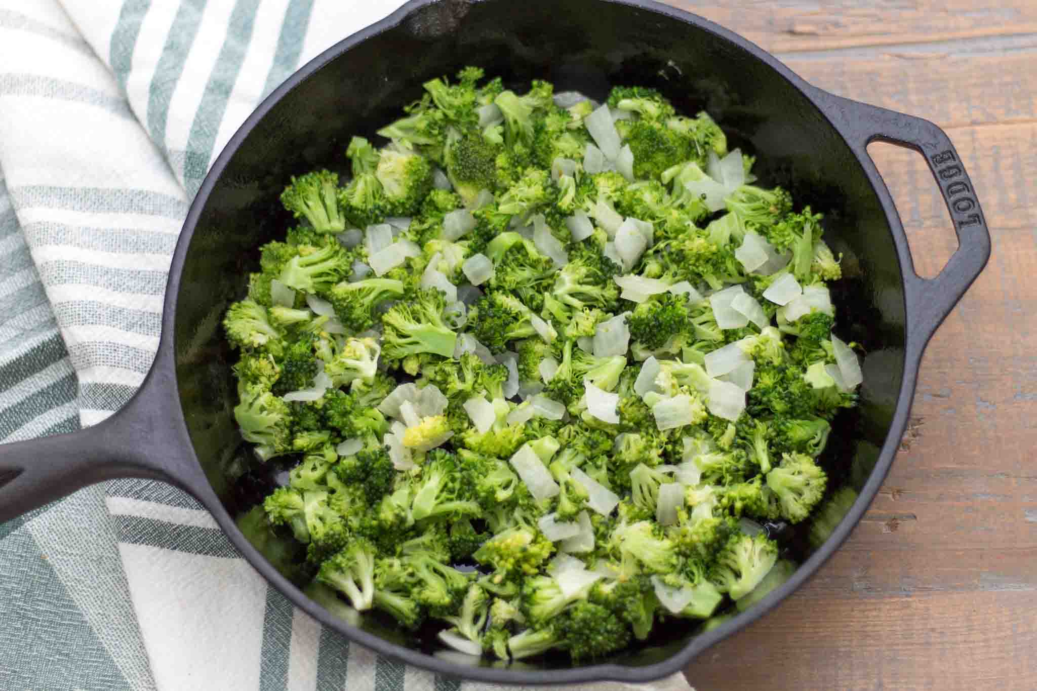 sauteed chopped broccoli florets and diced onion in a cast iron skillet greased with butter