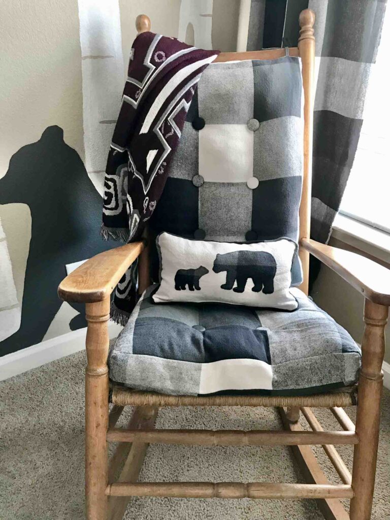 antique wood rocking chair with black and white handmade buffalo check seat cushions and woodland bear applique pillow