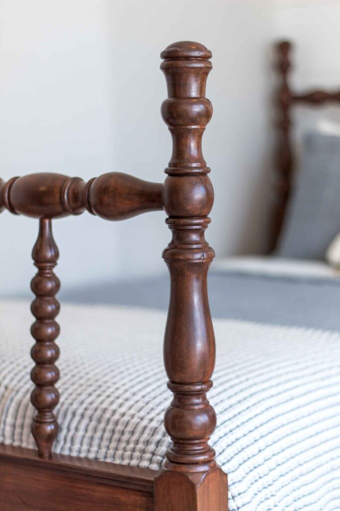 photo of an antique jenny lind footboard spindle post finished in a medium brown stain