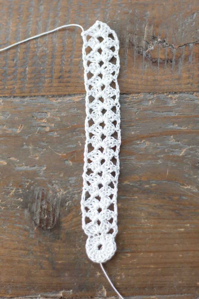 completed main body of the cross bookmark with one round, 17 rows of crochet stitches, and tied off with loose ends