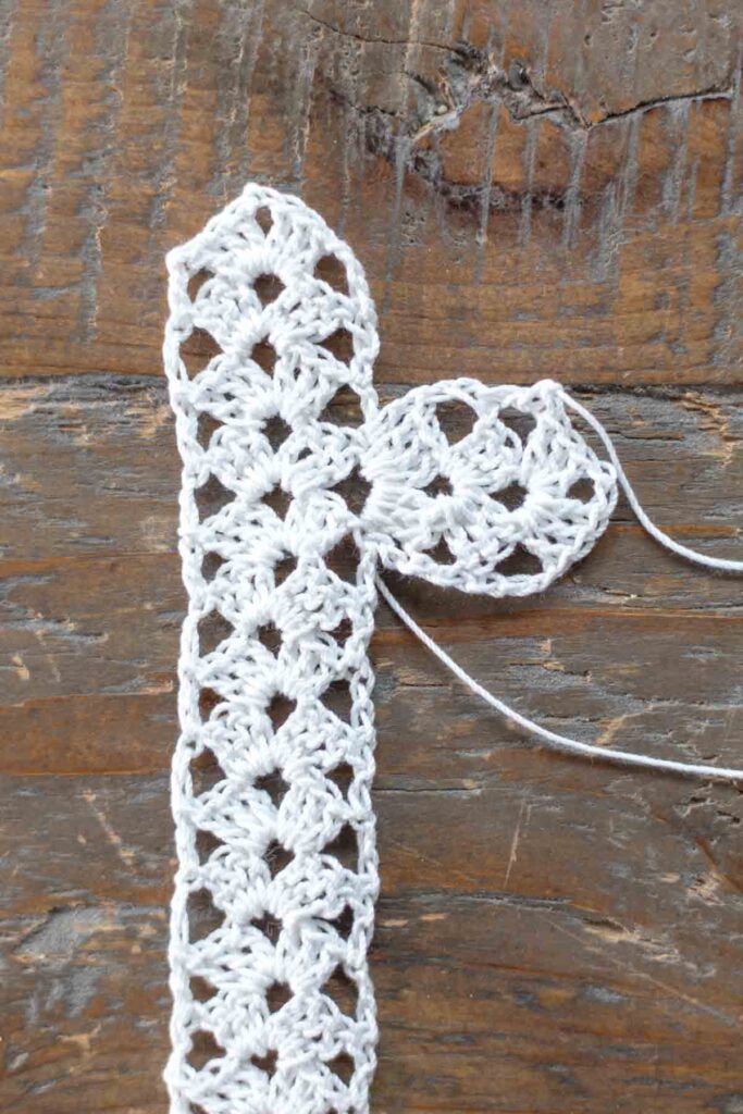 close-up of completed right arm of cross crocheted to the main body of the cross