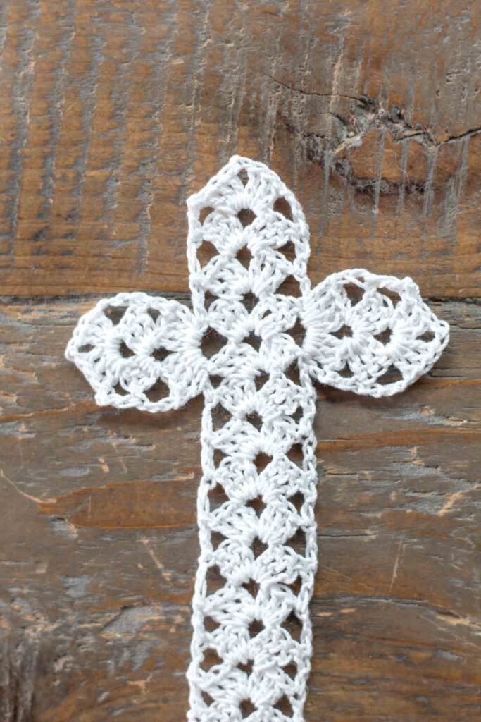 close-up of both the left and right arms of the cross completed and crocheted to the main body of the cross with loose ends woven in