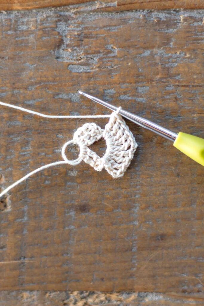 second row of right arm of the cross bookmark with a total of 9 triple crochets and two chain stitches