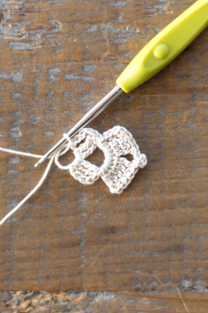 completed right arm of the cross bookmark with two rows of triple crochet stitches, chain stitches, and slip stitches